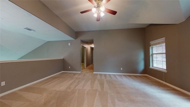 bonus room with ceiling fan, light colored carpet, and vaulted ceiling