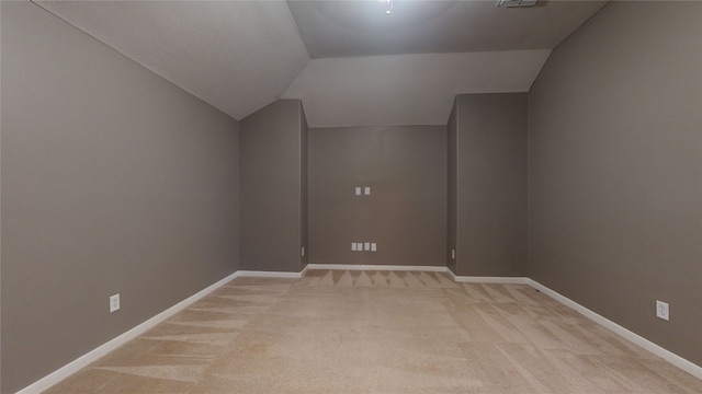 bonus room featuring light colored carpet and lofted ceiling