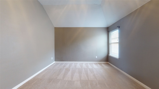 additional living space with light carpet and lofted ceiling