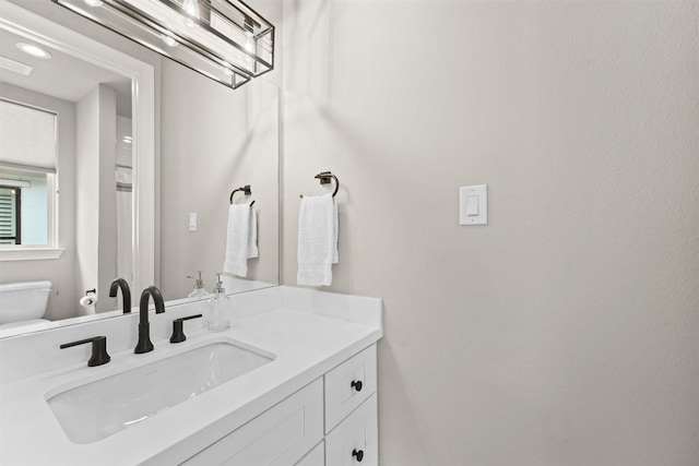 bathroom featuring vanity and toilet