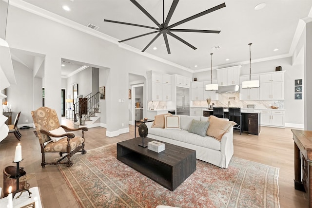 living room featuring light hardwood / wood-style flooring and ornamental molding