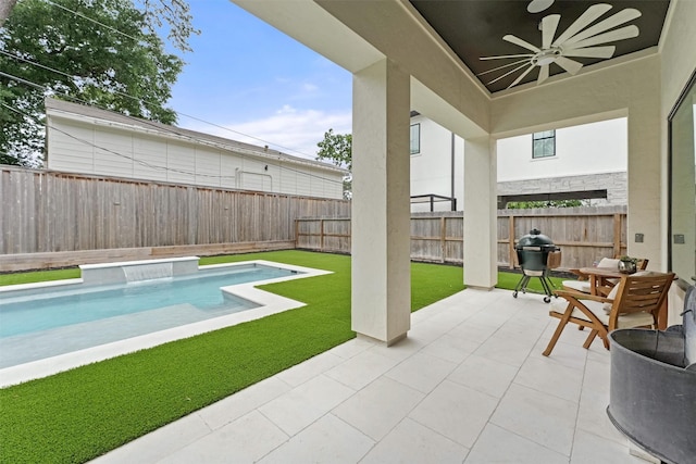 view of swimming pool featuring a lawn, a grill, ceiling fan, and a patio