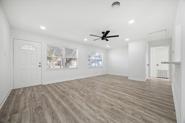 unfurnished living room with ceiling fan and light hardwood / wood-style flooring