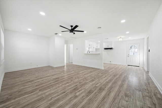 unfurnished living room with hardwood / wood-style floors and ceiling fan