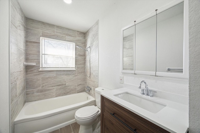 full bathroom with tiled shower / bath combo, toilet, and vanity