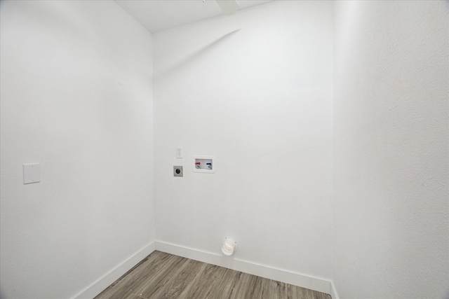 clothes washing area with electric dryer hookup, hookup for a washing machine, and hardwood / wood-style floors