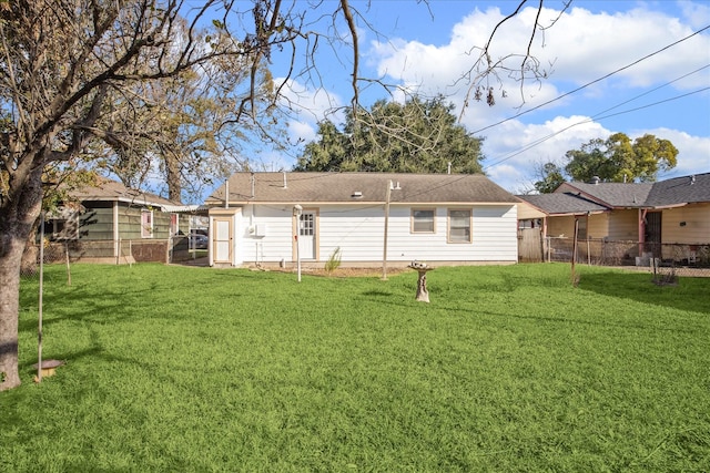 back of house with a yard