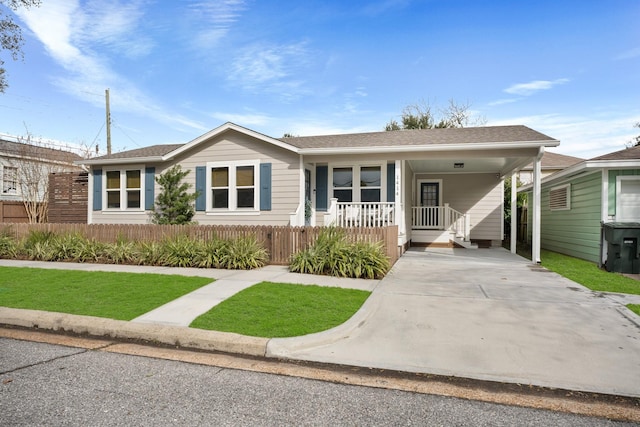 view of front of property with a carport and a front lawn