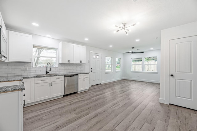 kitchen with light hardwood / wood-style floors, dishwasher, white cabinets, and sink