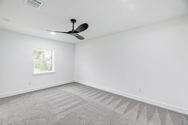 carpeted spare room with ceiling fan