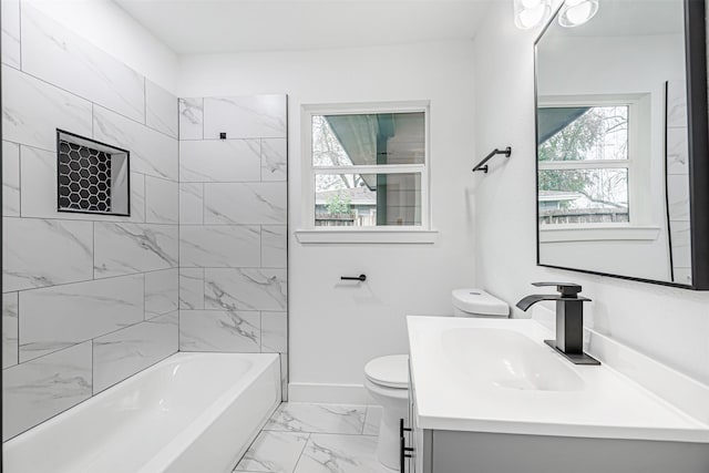 full bathroom featuring toilet, tiled shower / bath combo, and vanity