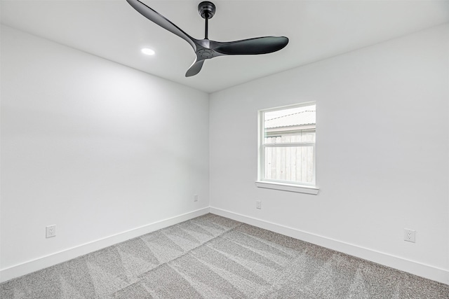 empty room featuring ceiling fan and light colored carpet