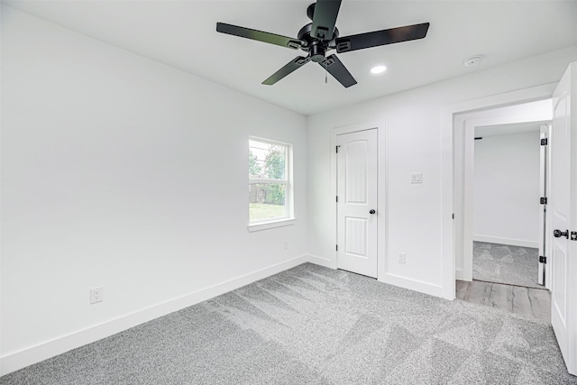 unfurnished bedroom featuring ceiling fan and light colored carpet