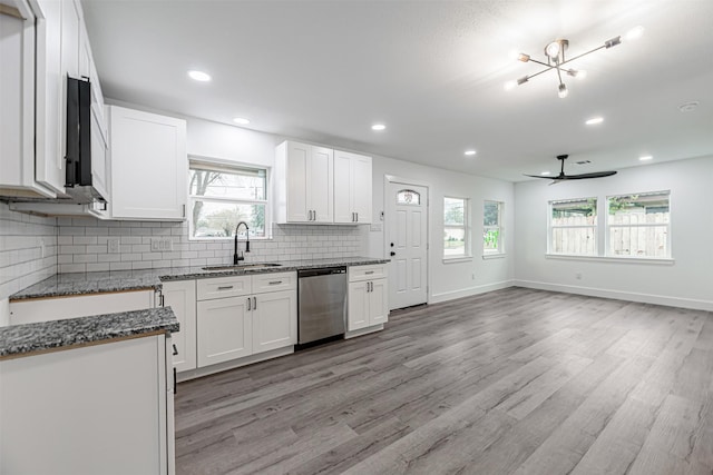 kitchen with light wood-type flooring, dishwasher, white cabinets, and sink