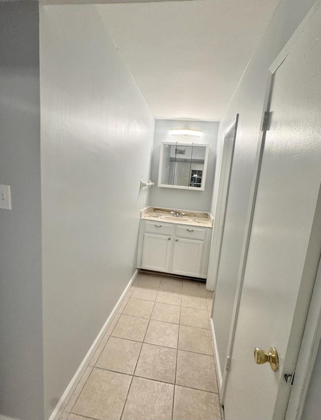 hall with sink and light tile patterned floors