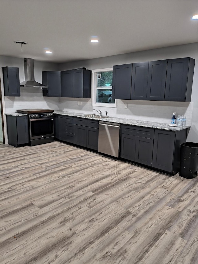 kitchen featuring dishwasher, wall chimney exhaust hood, black electric range, light stone counters, and light hardwood / wood-style flooring