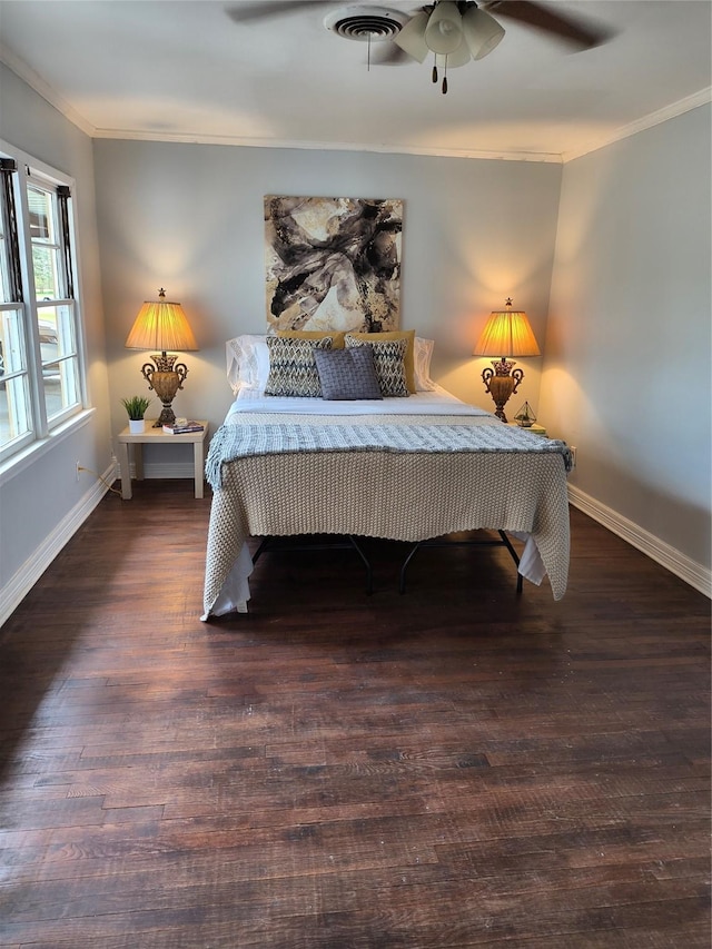 bedroom with ceiling fan, dark hardwood / wood-style floors, and ornamental molding