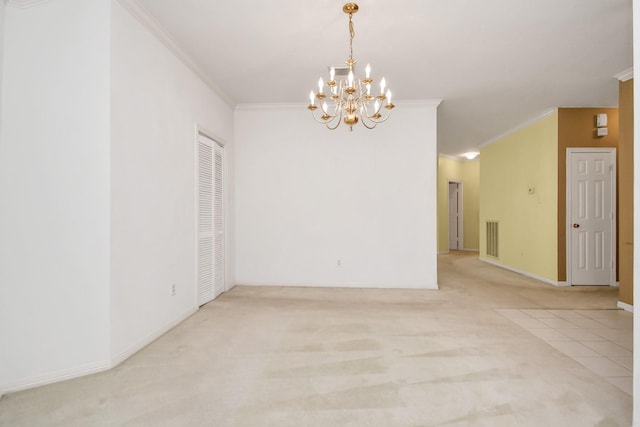 carpeted spare room featuring a chandelier and ornamental molding