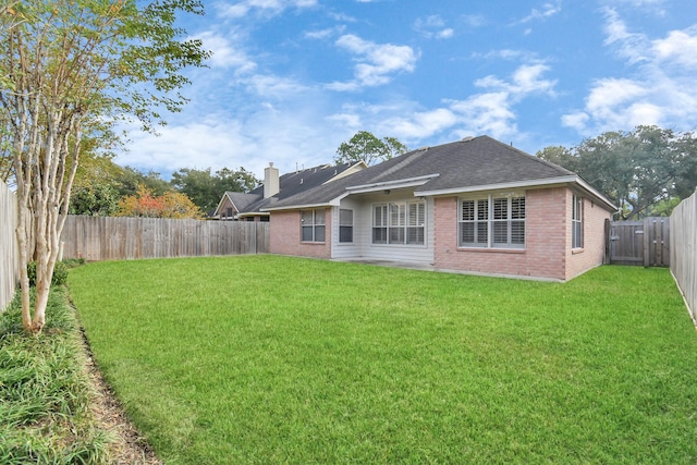 back of house with a yard