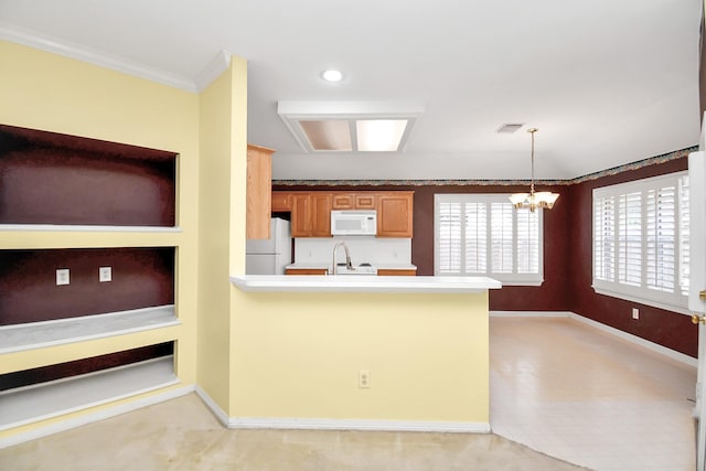 kitchen with an inviting chandelier, crown molding, pendant lighting, white appliances, and light carpet