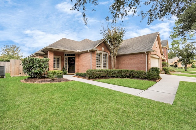 view of front of property with a garage and a front yard