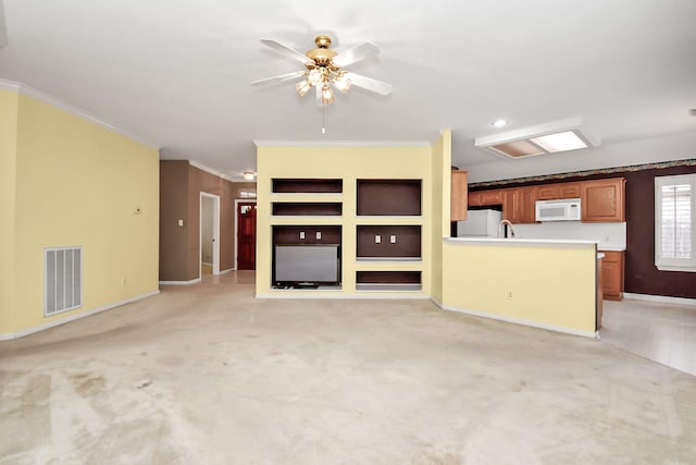 unfurnished living room featuring light carpet, ceiling fan, and ornamental molding