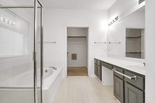 bathroom featuring shower with separate bathtub and vanity