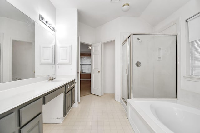 bathroom featuring shower with separate bathtub, vanity, and lofted ceiling