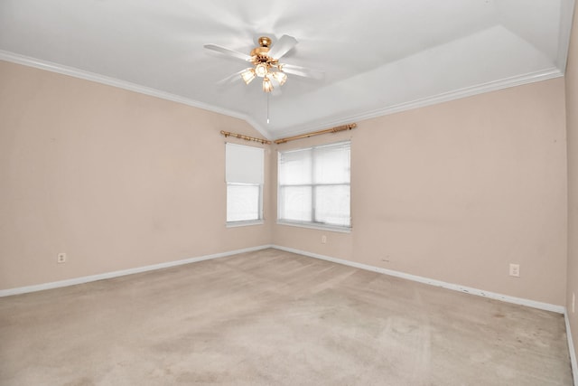 carpeted empty room featuring ceiling fan, vaulted ceiling, and ornamental molding