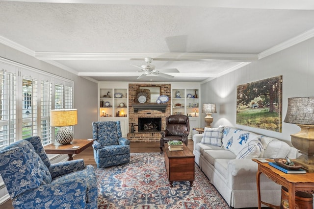 living room featuring built in features, beamed ceiling, crown molding, and a textured ceiling