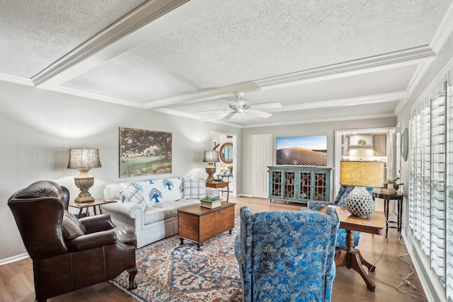 living room featuring wood-type flooring, a textured ceiling, and ceiling fan