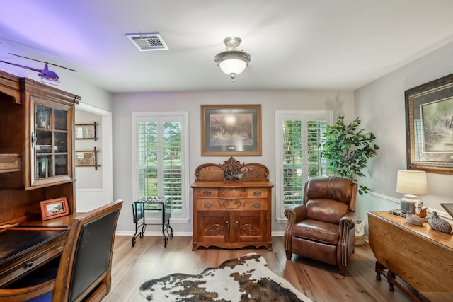 sitting room with a healthy amount of sunlight and light hardwood / wood-style flooring