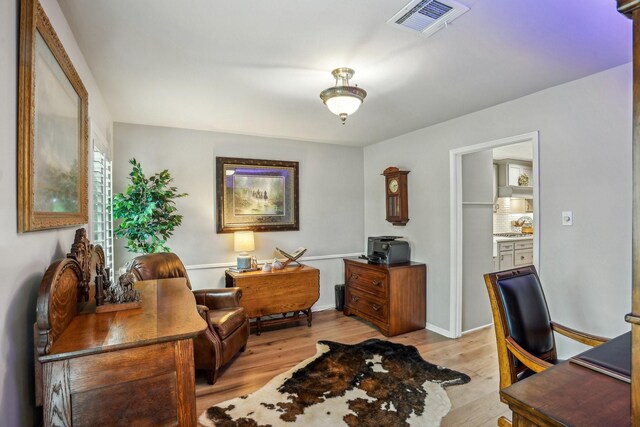 office with light hardwood / wood-style floors