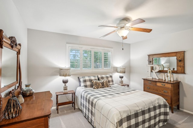 bedroom featuring ceiling fan and light carpet