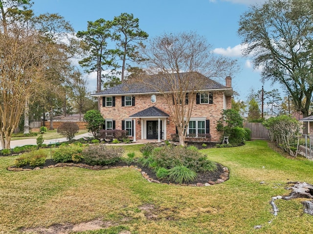 colonial-style house with a front yard