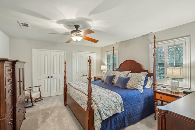 bedroom with ceiling fan and light colored carpet