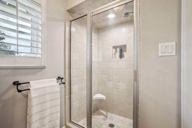 bathroom featuring a shower with shower door