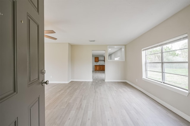 unfurnished room featuring ceiling fan and light hardwood / wood-style flooring