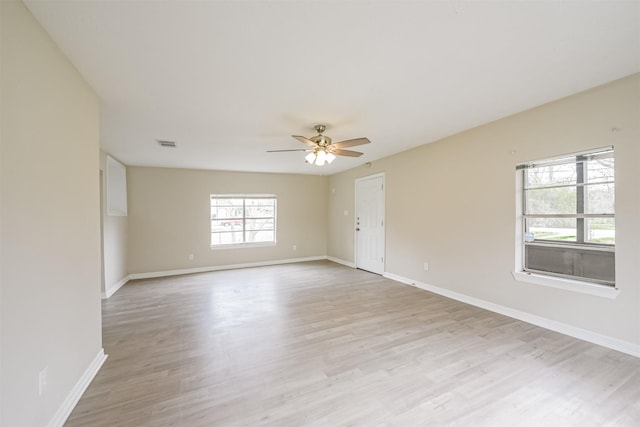 spare room featuring light hardwood / wood-style floors and ceiling fan