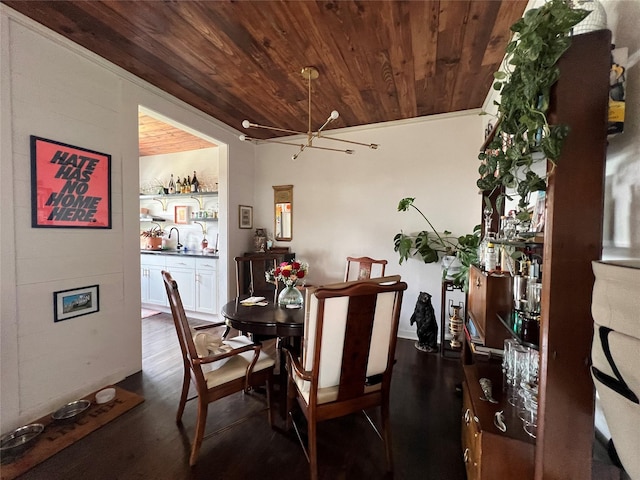 dining room featuring dark hardwood / wood-style flooring, wooden ceiling, crown molding, and a chandelier