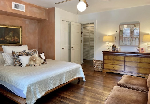 bedroom with a closet, dark hardwood / wood-style floors, and ceiling fan