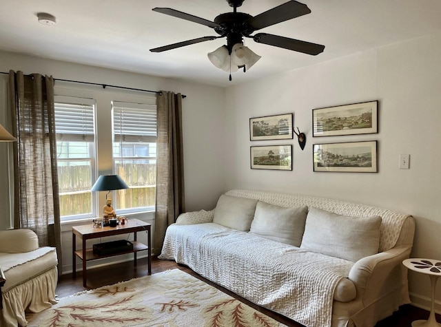 sitting room with ceiling fan and wood-type flooring