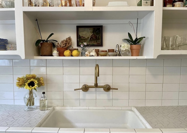 room details featuring tasteful backsplash and sink