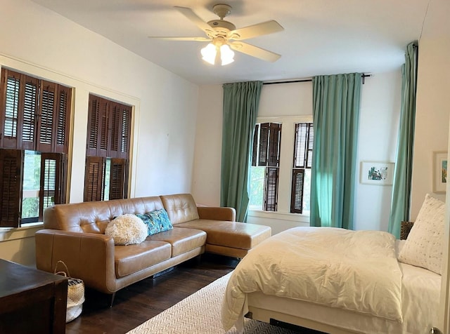 bedroom with multiple windows, ceiling fan, and dark hardwood / wood-style flooring