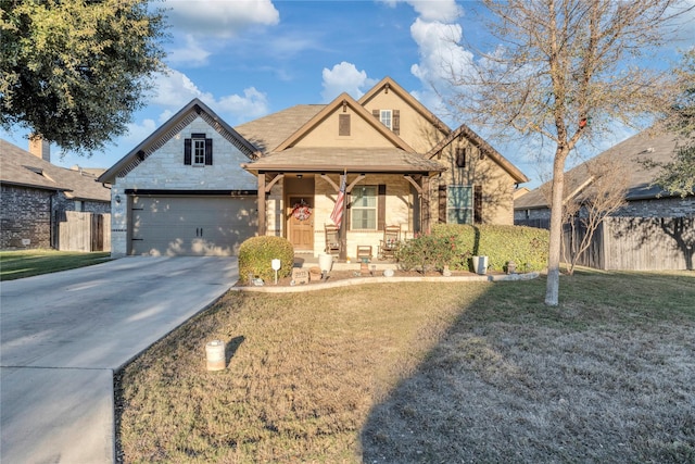 view of front of house with a porch, a front yard, and a garage