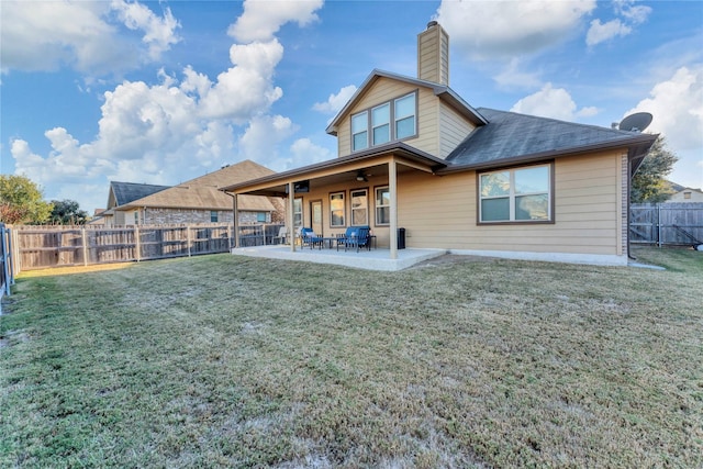 back of house featuring a patio area, ceiling fan, and a yard