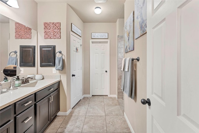 bathroom featuring tile patterned flooring and vanity