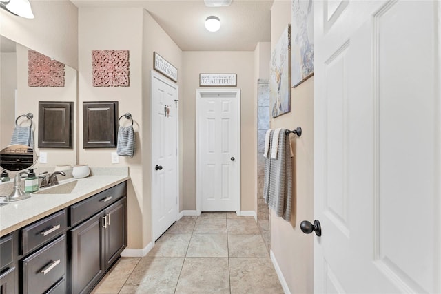 bathroom with tile patterned flooring and vanity