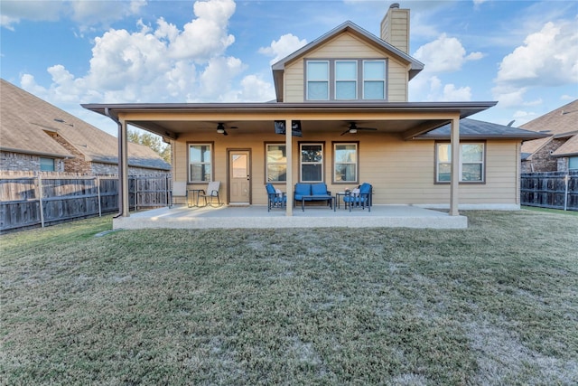 rear view of property featuring a lawn, ceiling fan, outdoor lounge area, and a patio