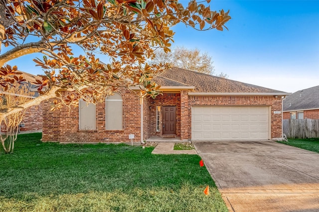 view of front of property featuring a garage and a front lawn